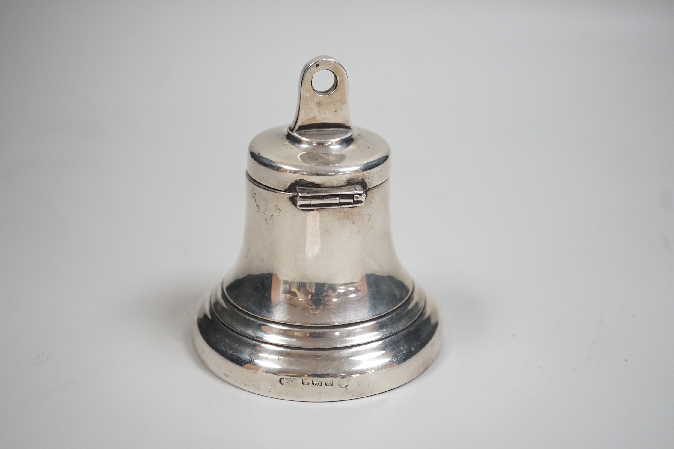 A George V silver mounted inkwell, modelled as a bell, Birmingham, 1935, height 97mm.